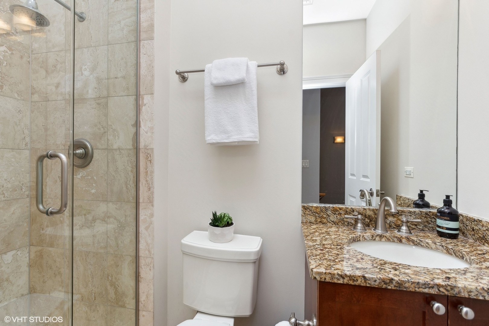 3003 West Cornelia Avenue Chicago, IL 60618 - Photo 13 of 25 a bathroom with a granite countertop sink and a mirror