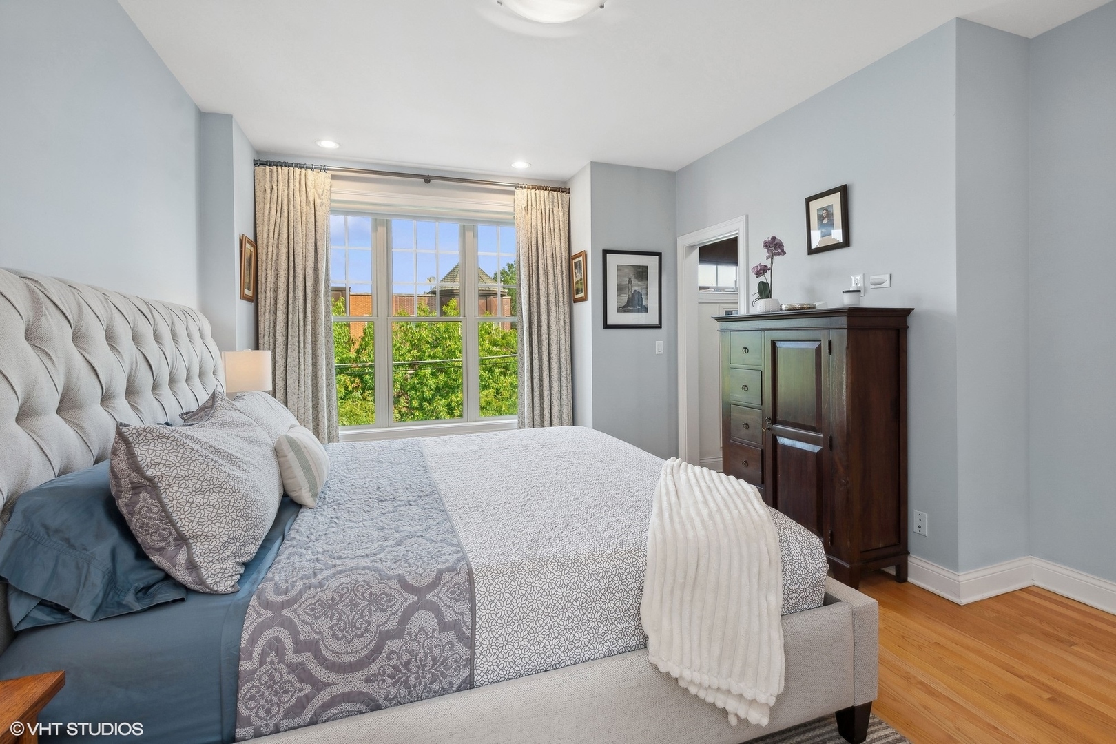 3003 West Cornelia Avenue Chicago, IL 60618 - Photo 7 of 25 a bedroom with a bed and wooden floor