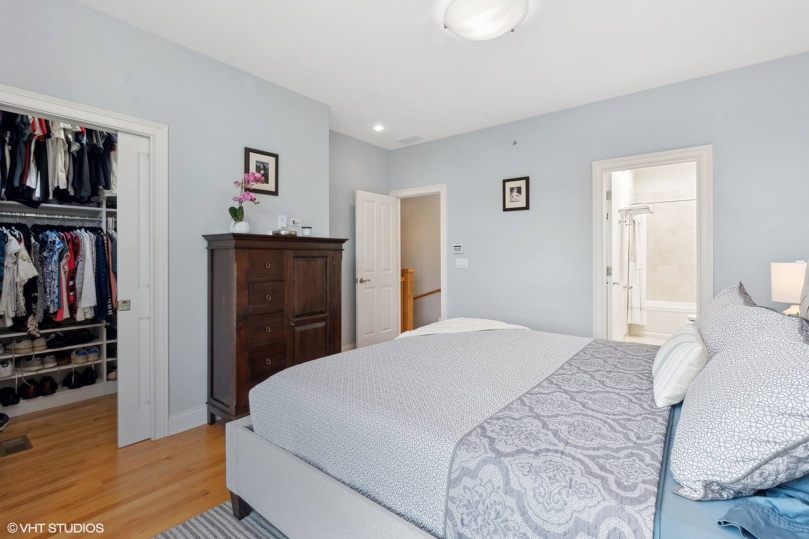 3003 West Cornelia Avenue Chicago, IL 60618 - Photo 8 of 25 a bedroom with a bed and a book shelf