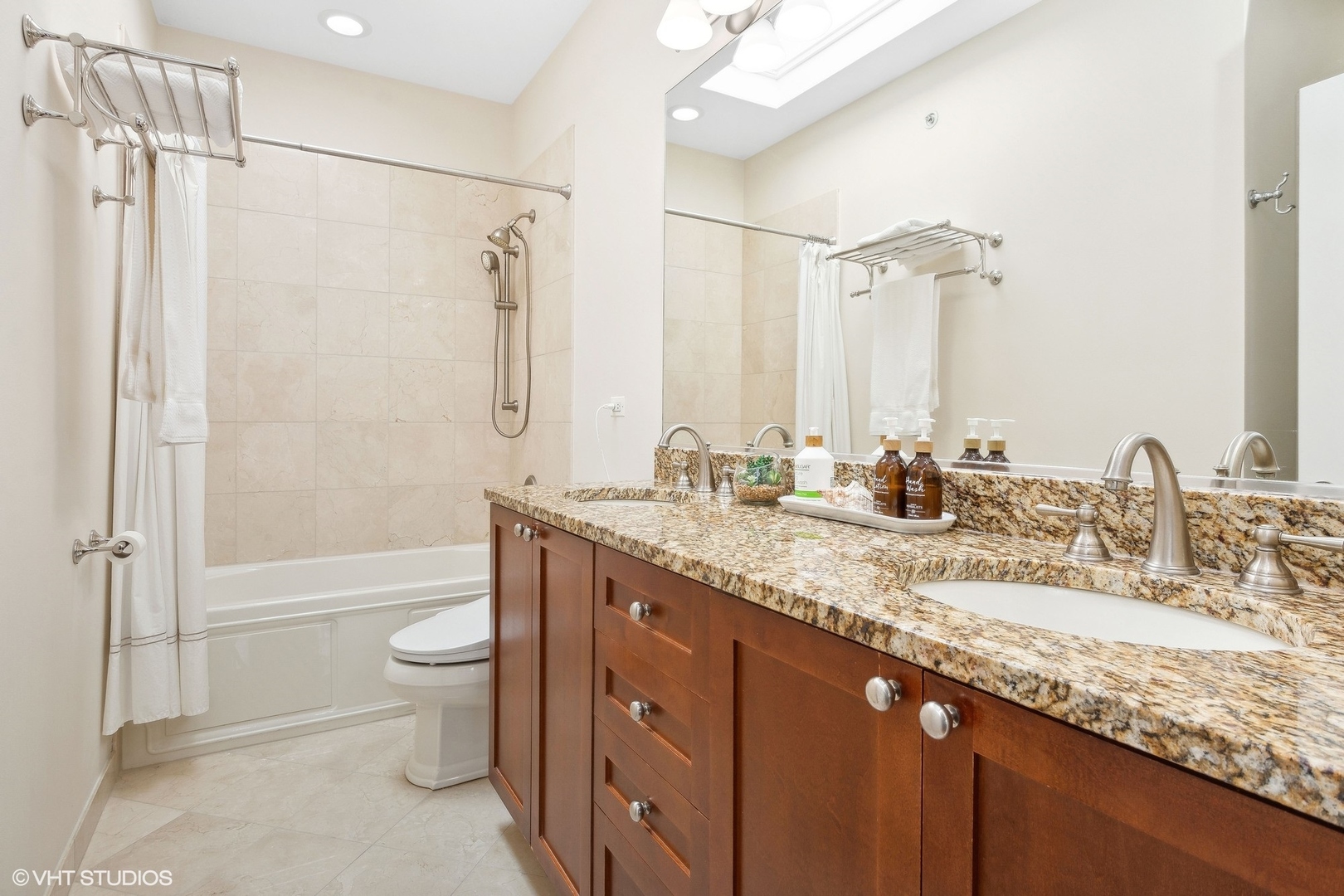 3003 West Cornelia Avenue Chicago, IL 60618 - Photo 9 of 25 a bathroom with a granite countertop sink a toilet and shower