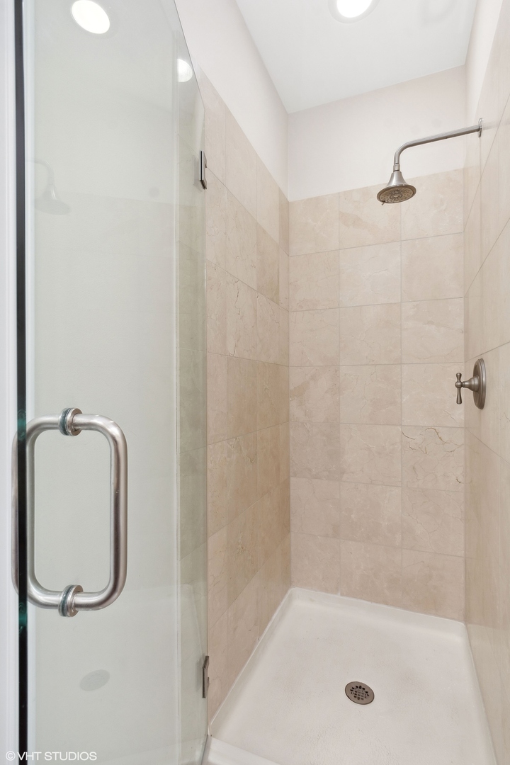 3003 West Cornelia Avenue Chicago, IL 60618 - Photo 10 of 25 a bathroom with a shower and a bathtub