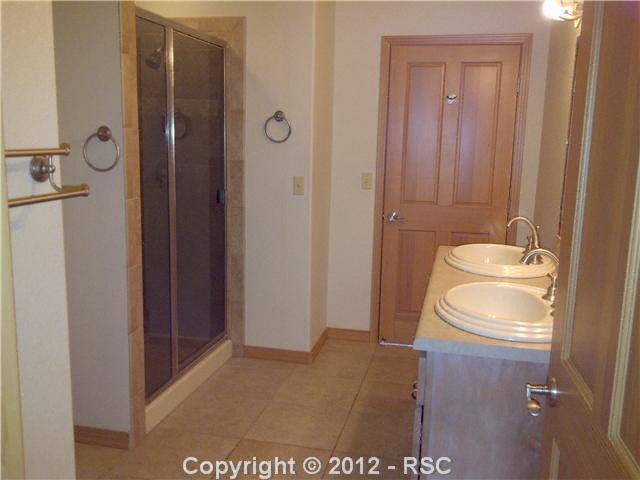 18518 Wetherill Road Monument, CO 80132 - Photo 12 of 16 Jack-and-Jill Bath between Bedrooms 3 & 4. Basement also has guest powder room.