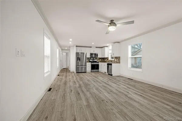 a view of a kitchen with a stove cabinets and wooden floor