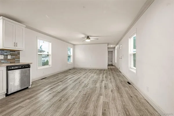 a view of a kitchen with a sink cabinets wooden floor and a window