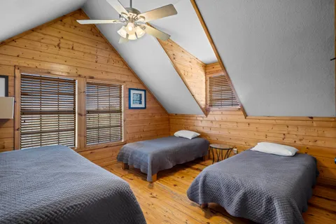 a bedroom with two beds and a chandelier