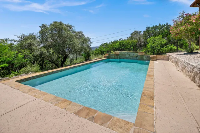 a view of a pool with a yard
