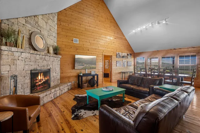a living room with furniture a fireplace and a flat screen tv