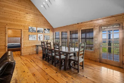 a dining room with furniture and wooden floor