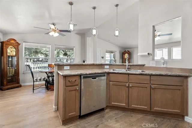 a kitchen with a sink a counter space appliances and a chandelier