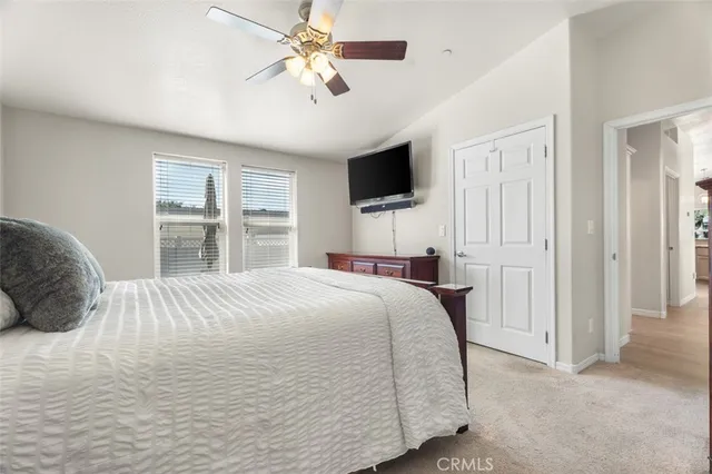 a bedroom with a large bed and a flat screen tv