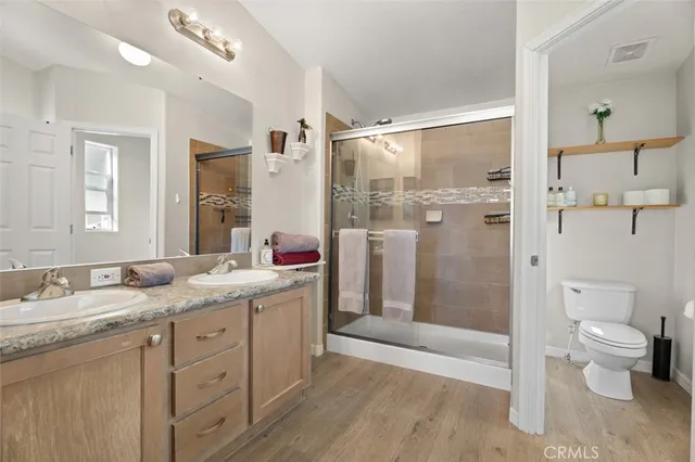 a bathroom with a granite countertop sink toilet and shower
