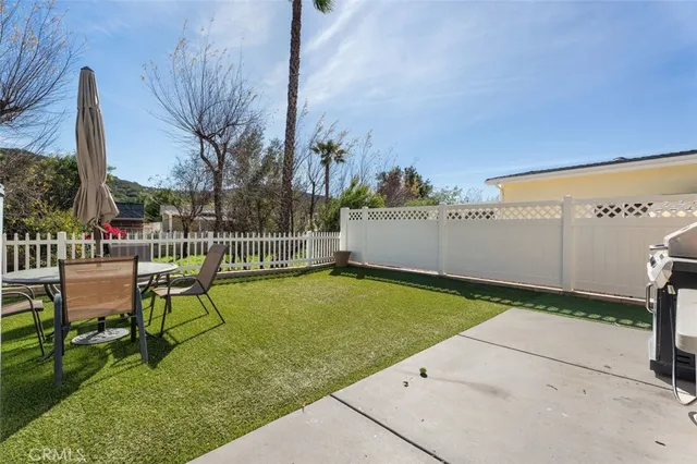 a view of a chair and table on the garden