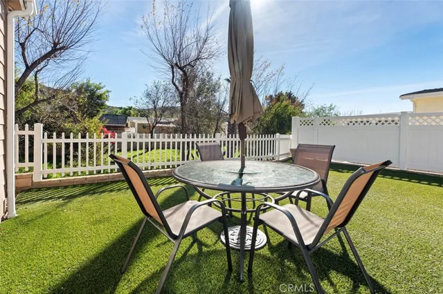 a view of a chairs and table in patio