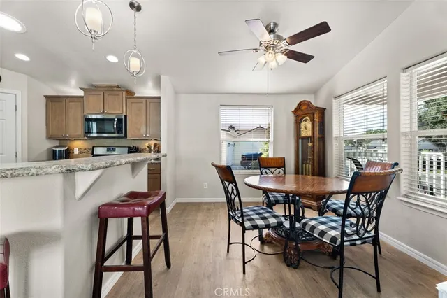 a view of a dining room with furniture and a large window