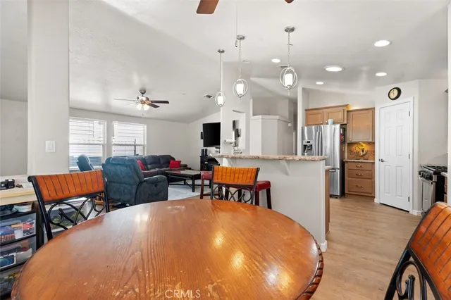 a living room with dining room and wooden floor