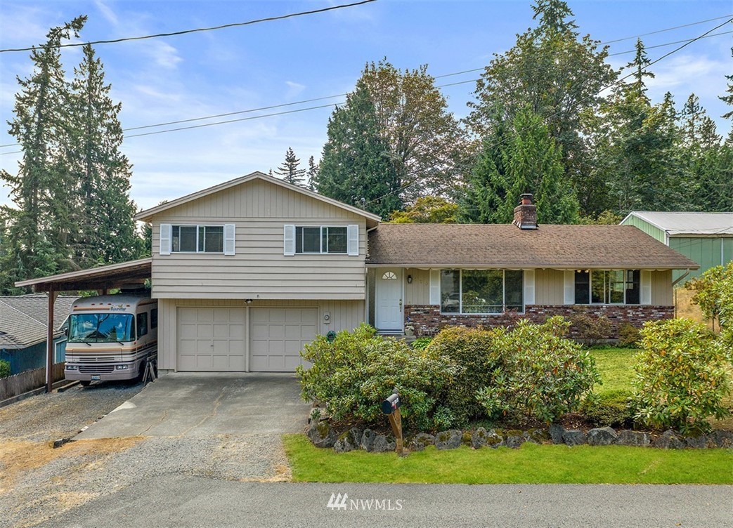 120 161st Street Southeast Bothell, WA 98012 - Photo 3 of 26 a front view of a house with a garden