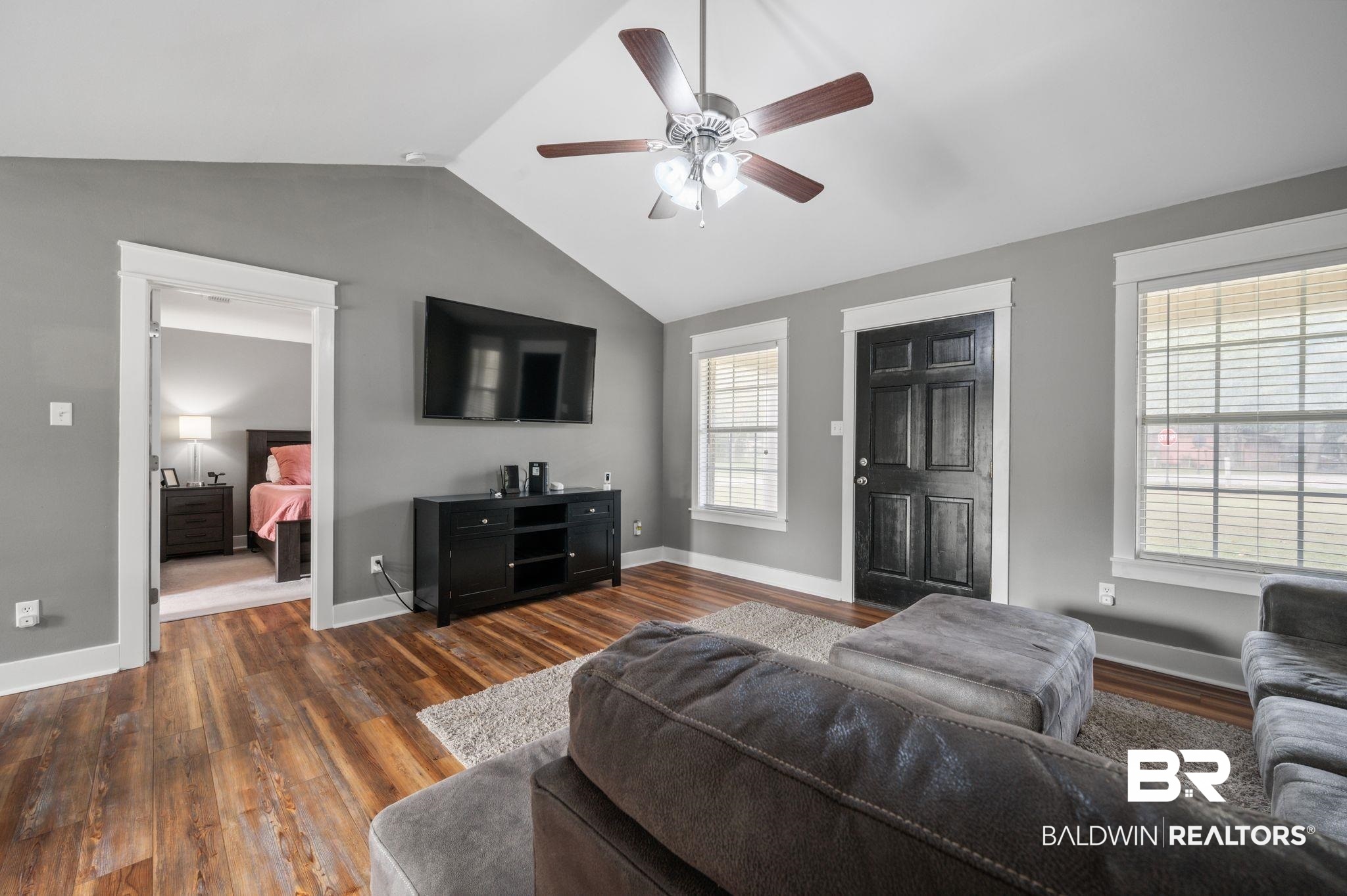 1107 North Oak Street Loxley, AL 36551 - Photo 4 of 40 Living room with dark wood-type flooring, ceiling fan, and vaulted ceiling