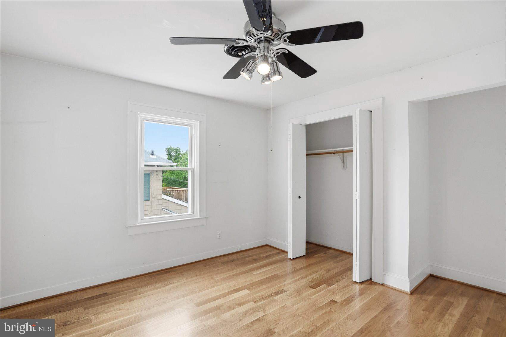 24 Normal Terrace Baltimore, MD 21286 - Photo 28 of 37 a view of an empty room with wooden floor and a window