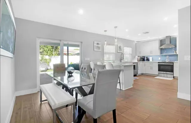 a dining room with furniture and a kitchen view
