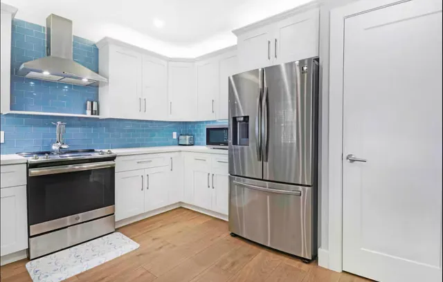 a kitchen with granite countertop stainless steel appliances and wooden cabinets