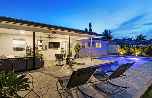 a view of a tennis ground with large trees