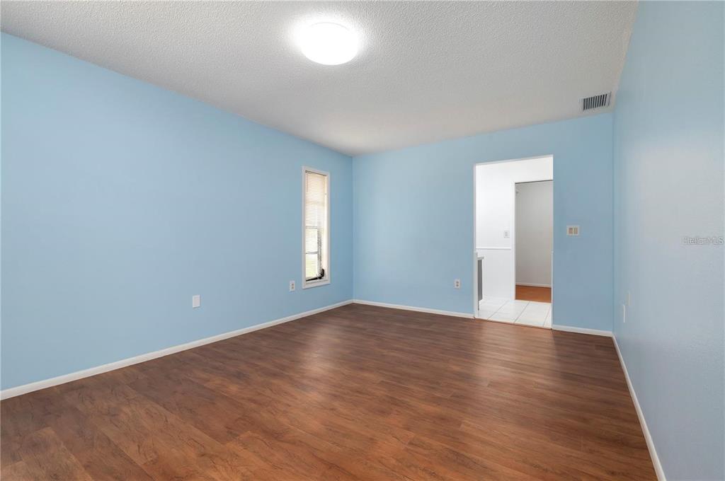 133 1st Avenue Nokomis, FL 34275 - Photo 20 of 32 a view of an empty room with window and wooden floor