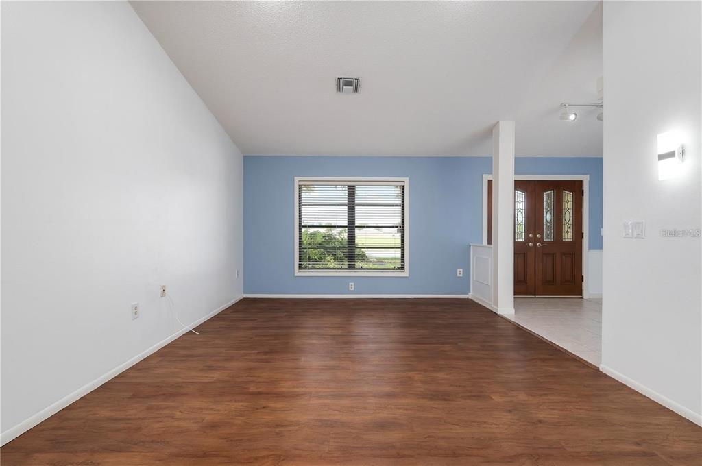 133 1st Avenue Nokomis, FL 34275 - Photo 25 of 32 a view of an empty room with window and wooden floor