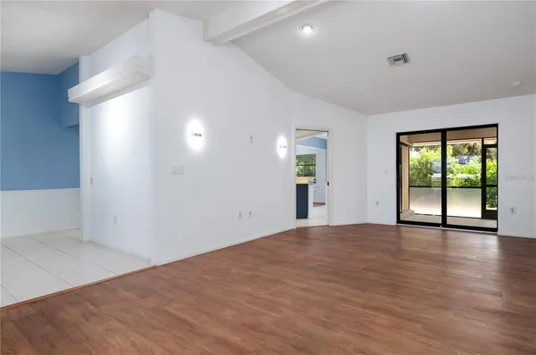 wooden floor in an empty room with a window