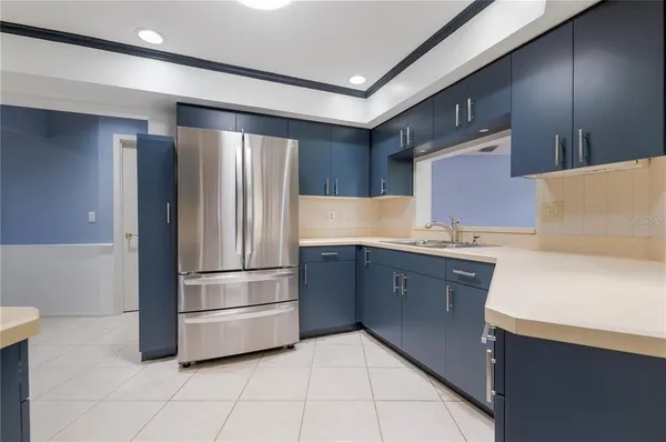 a kitchen with granite countertop a refrigerator and a sink