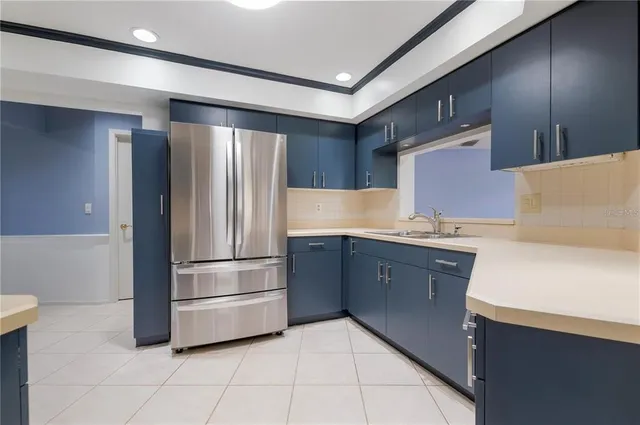 a kitchen with granite countertop a refrigerator and a sink