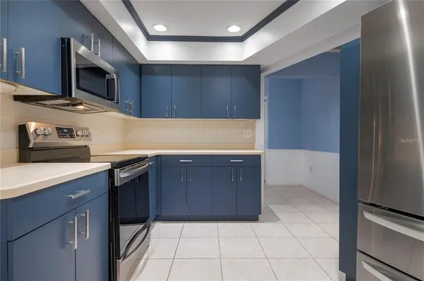 a kitchen with stainless steel appliances a refrigerator and a stove
