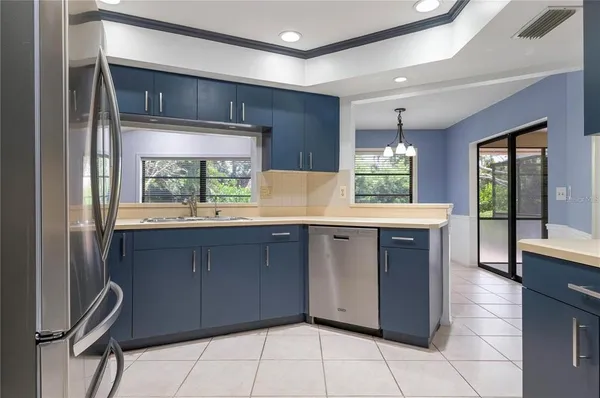 a kitchen with granite countertop a stove a sink and a microwave