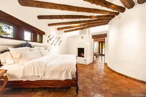 a spacious bedroom with a bed and a chair