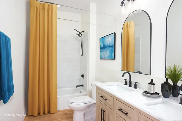a bathroom with a granite countertop sink mirror and toilet