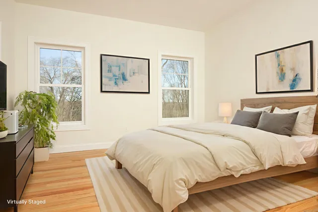 a bedroom with a bed and a painting on the wall