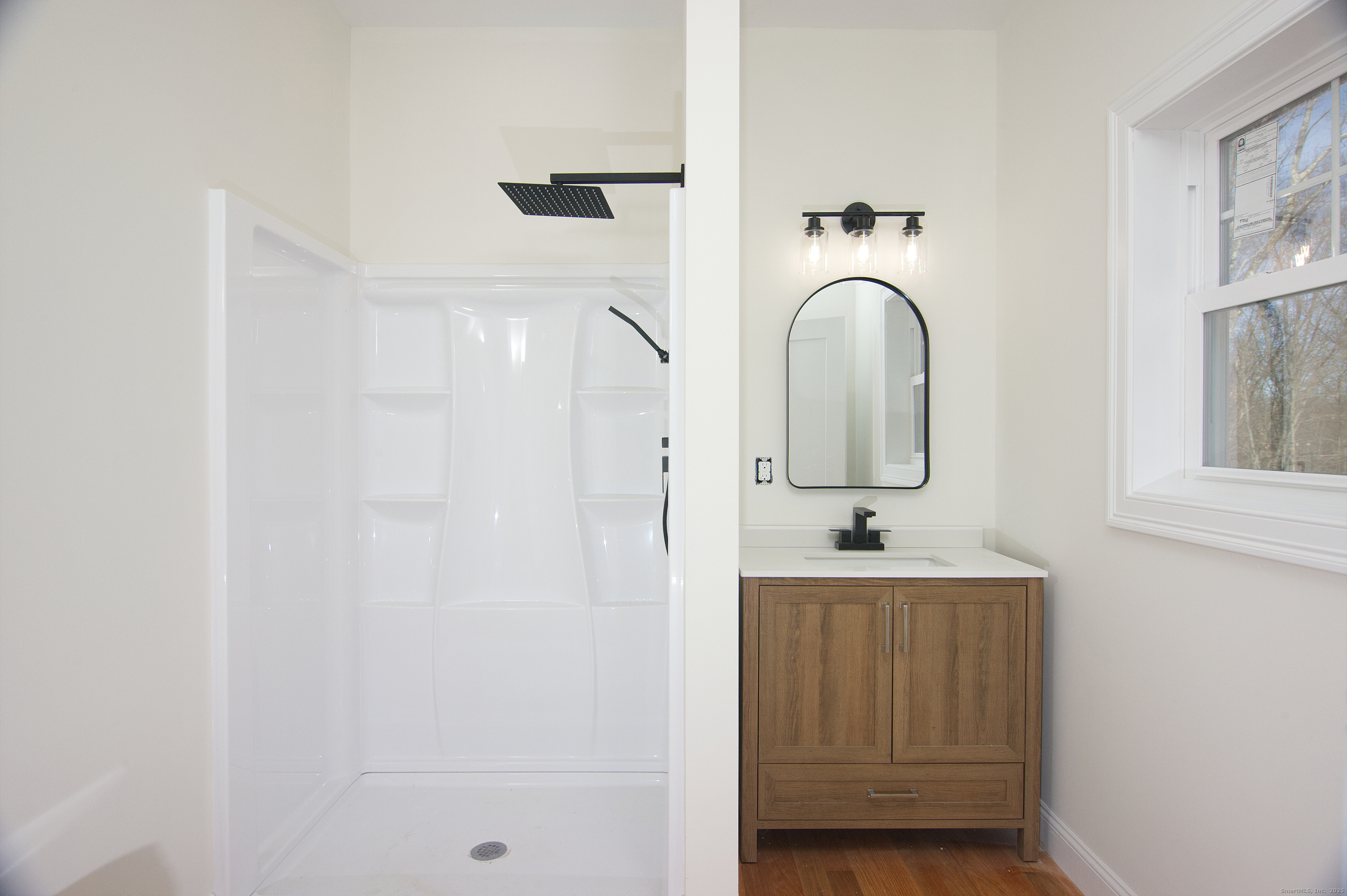 151 Benz Street Ansonia, CT 06401 - Photo 18 of 29 a bathroom with a sink and mirror with bathtub