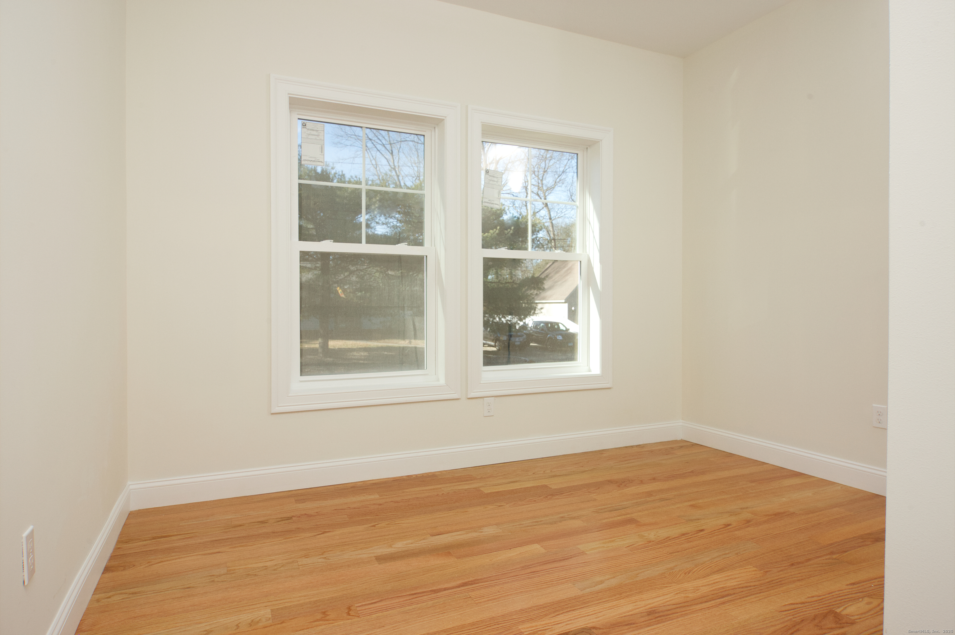 151 Benz Street Ansonia, CT 06401 - Photo 20 of 29 an empty room with wooden floor and windows