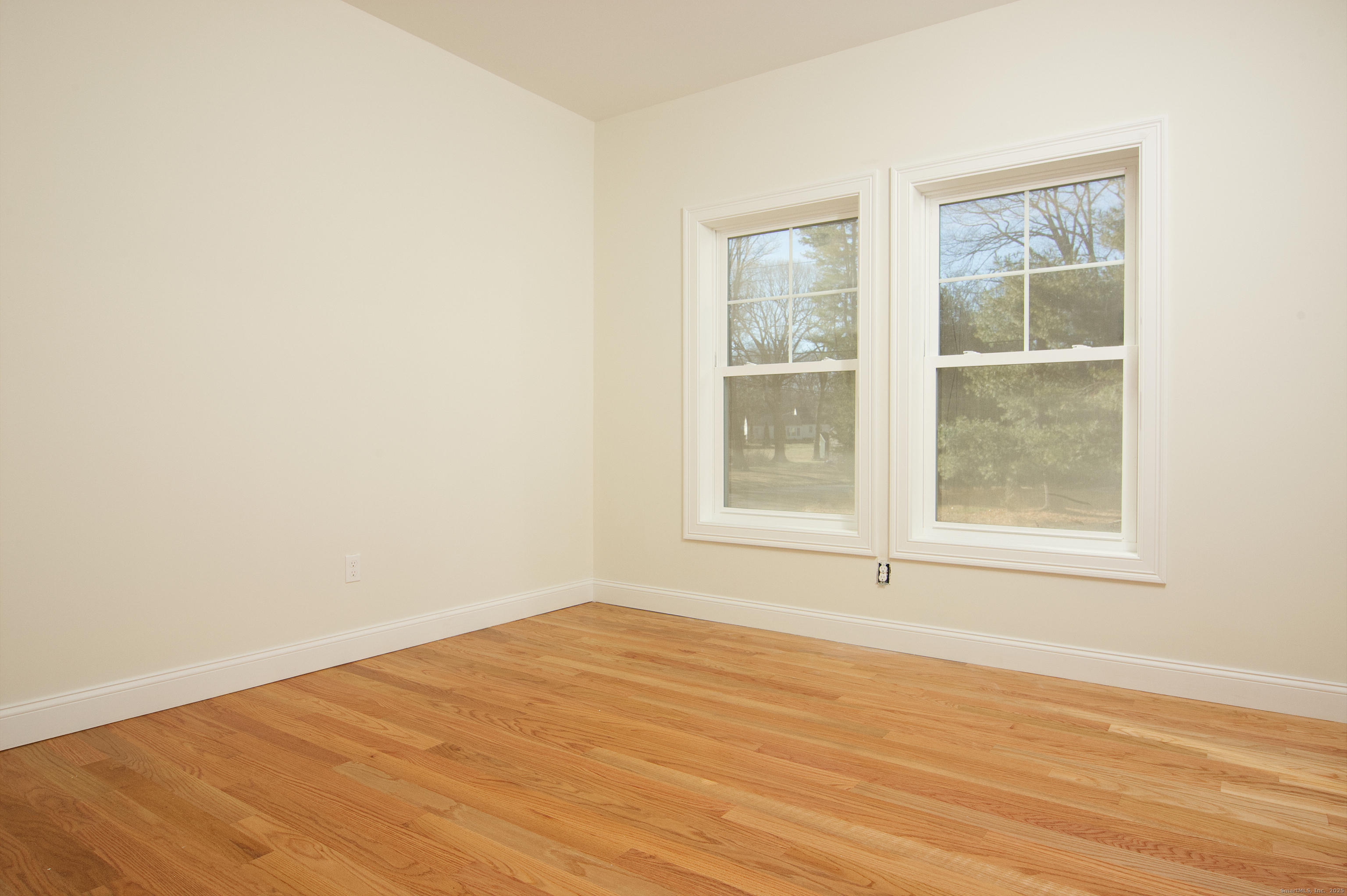 151 Benz Street Ansonia, CT 06401 - Photo 23 of 29 an empty room with wooden floor and windows