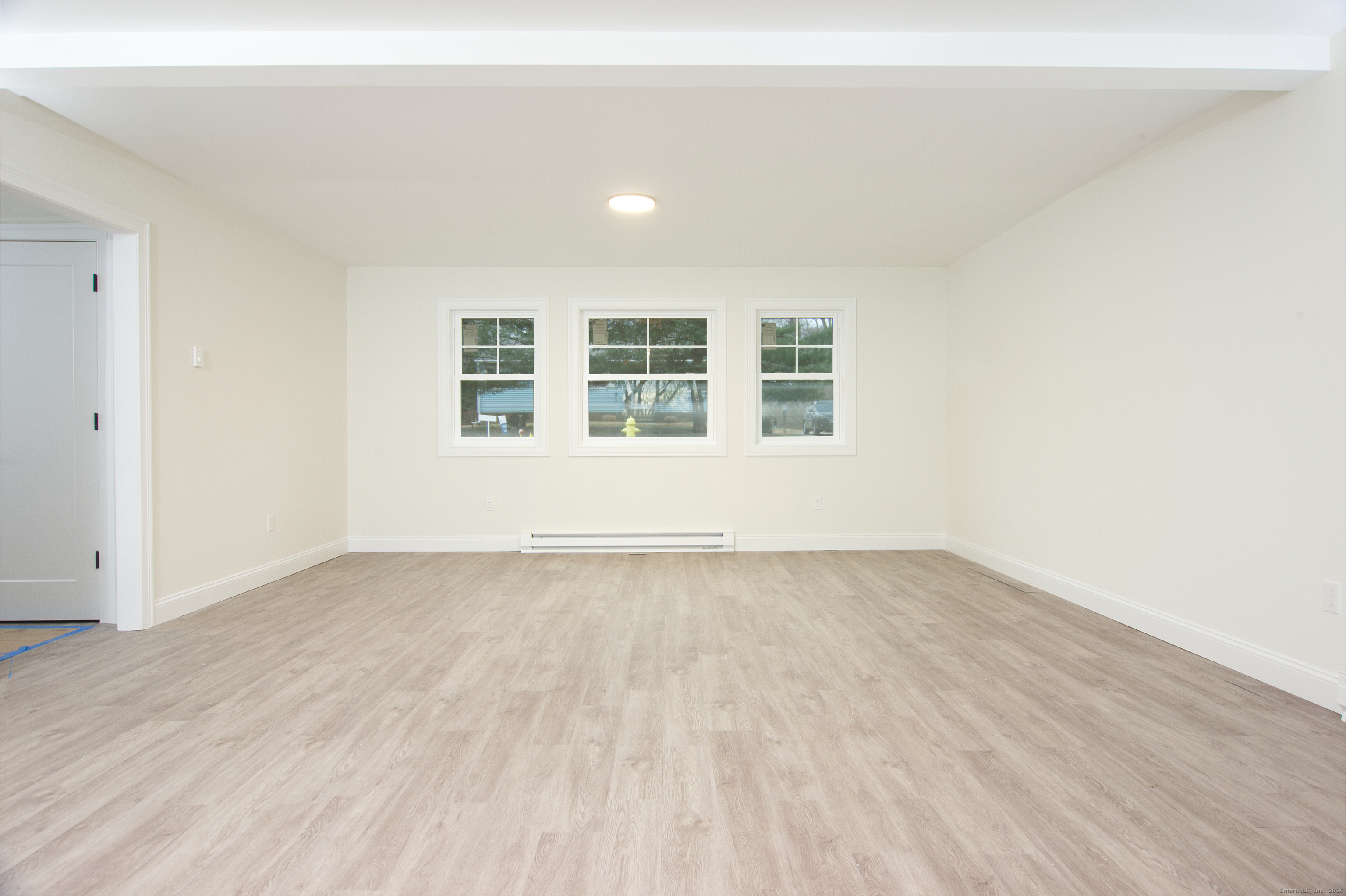 151 Benz Street Ansonia, CT 06401 - Photo 27 of 29 an empty room with wooden floor and windows
