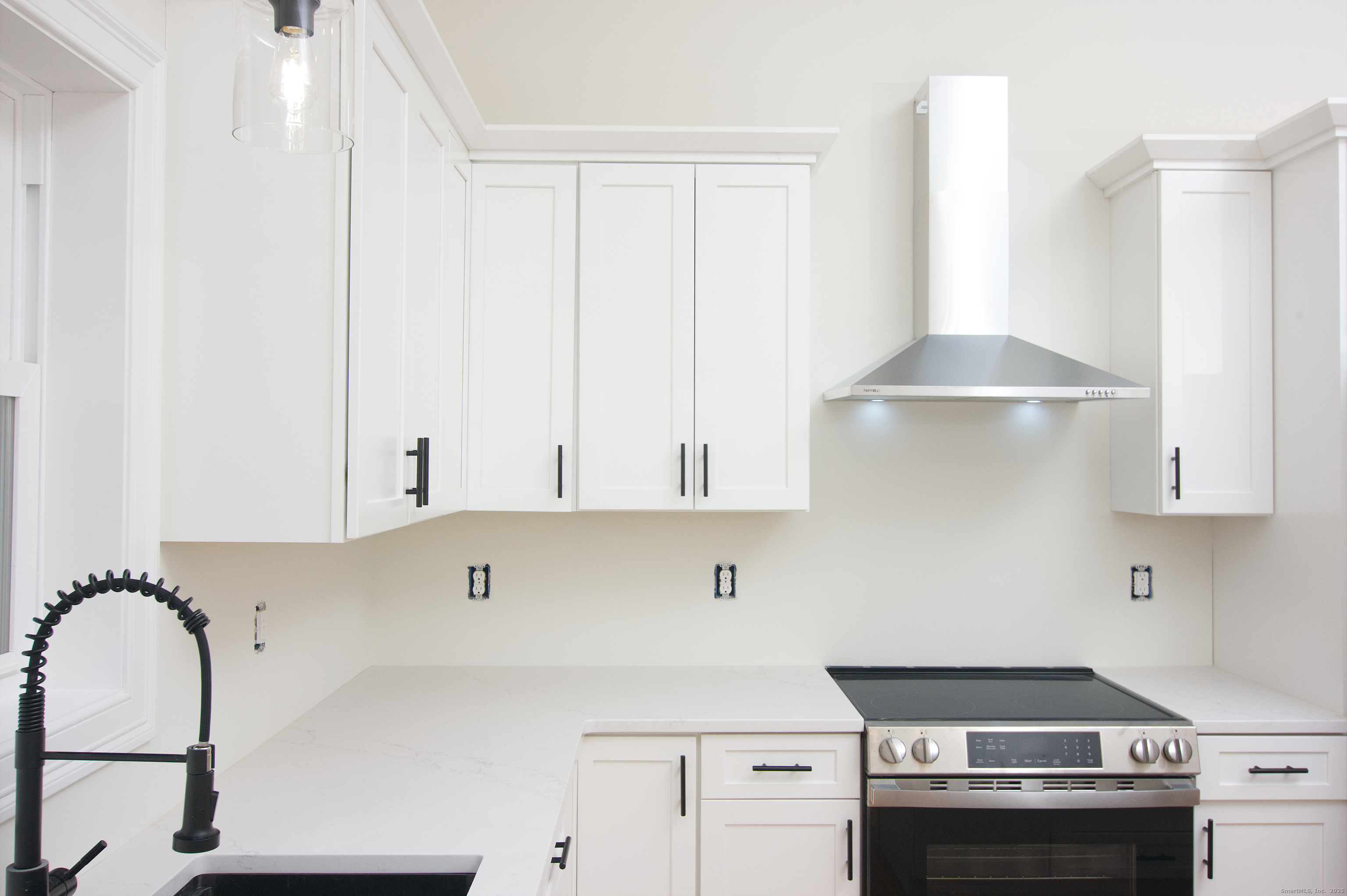 151 Benz Street Ansonia, CT 06401 - Photo 8 of 29 a kitchen with stainless steel appliances granite countertop a stove a sink and a white cabinets