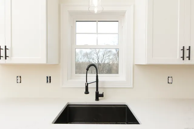 a kitchen with a sink and a window