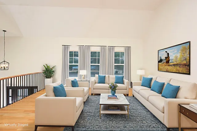 a living room with furniture rug and window