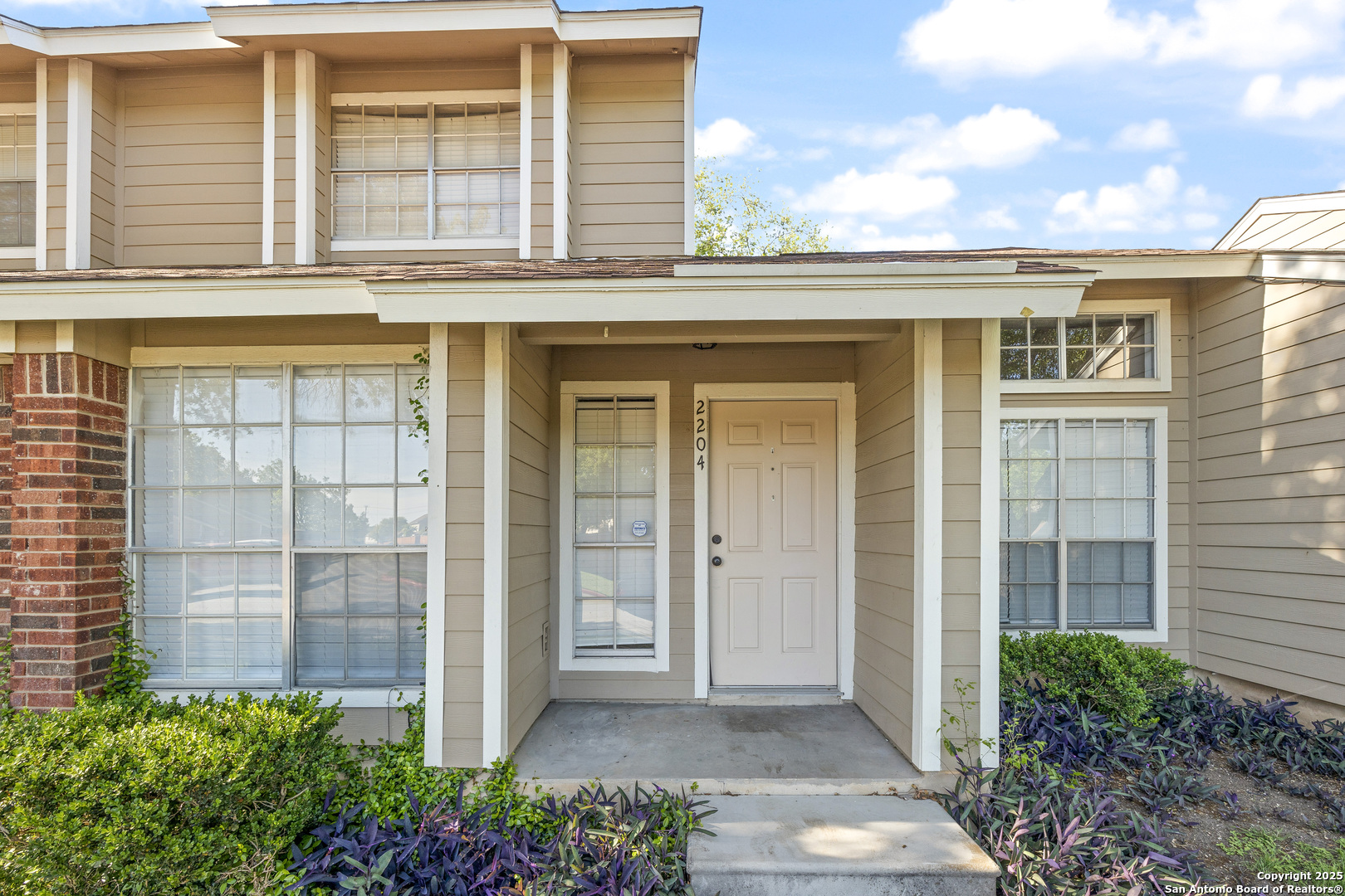 front view of a brick house with a large windows
