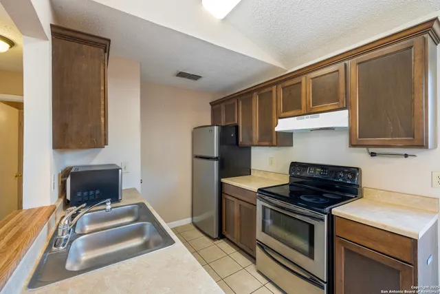 a kitchen that has a sink and a stove
