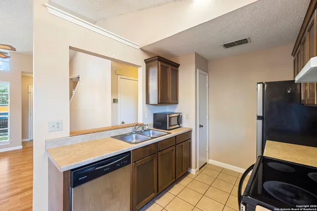 a kitchen that has a sink and a stove