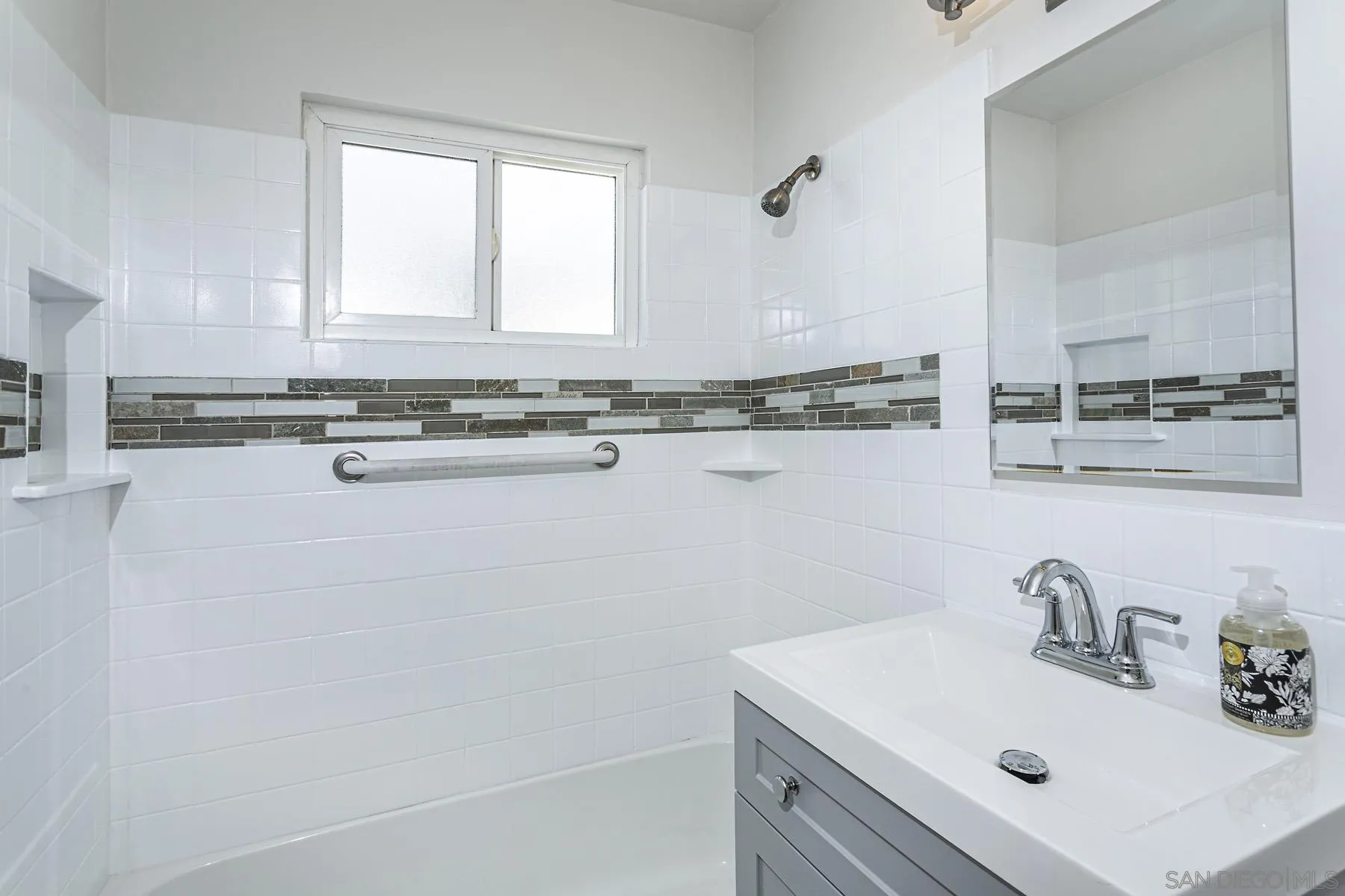 802 Vanderbilt Place San Diego, CA 92103 - Photo 11 of 14 a bathroom with a sink and a mirror