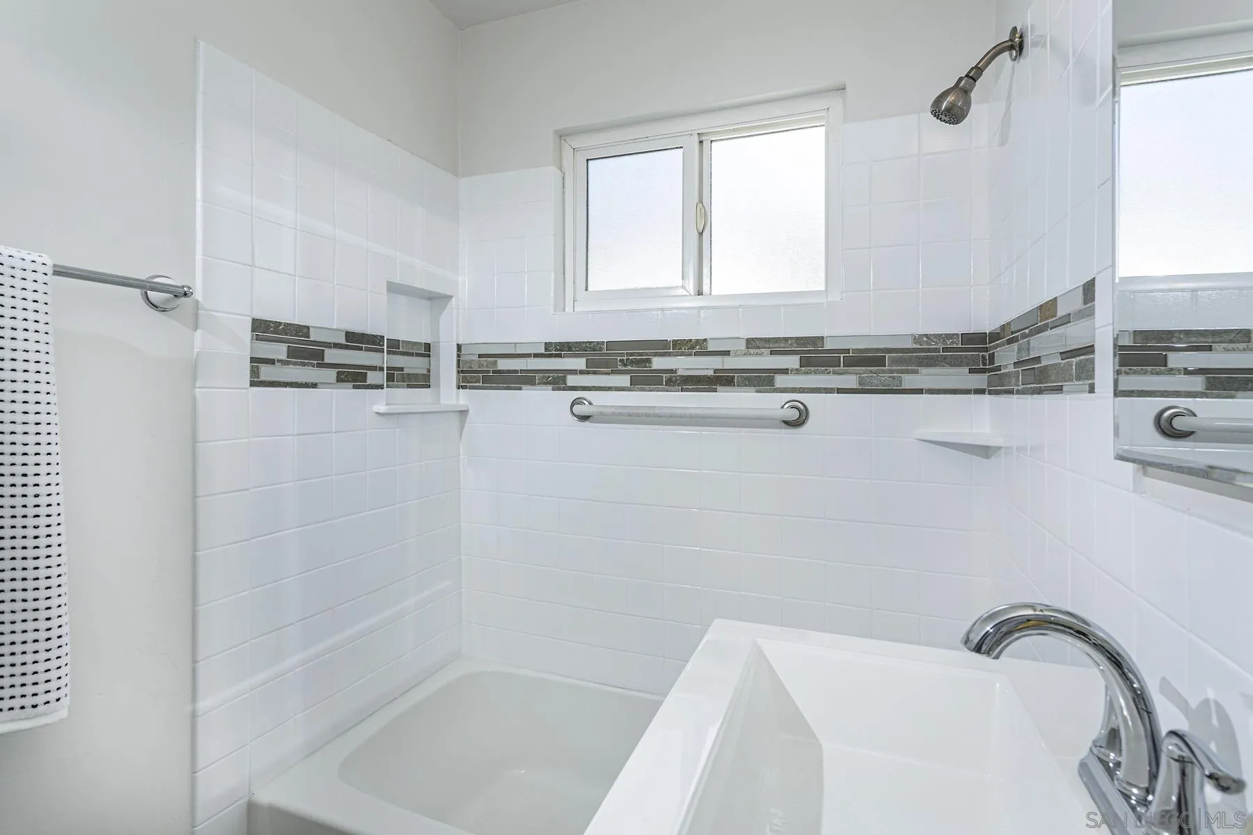 802 Vanderbilt Place San Diego, CA 92103 - Photo 12 of 14 a bathroom with a granite countertop sink a mirror and a bathtub