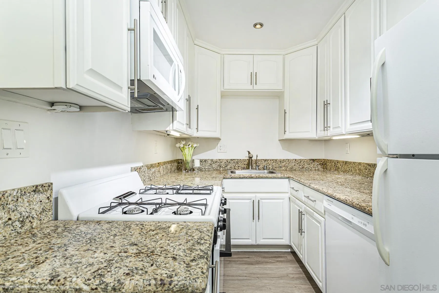 802 Vanderbilt Place San Diego, CA 92103 - Photo 8 of 14 a kitchen with stainless steel appliances granite countertop a sink stove and cabinets