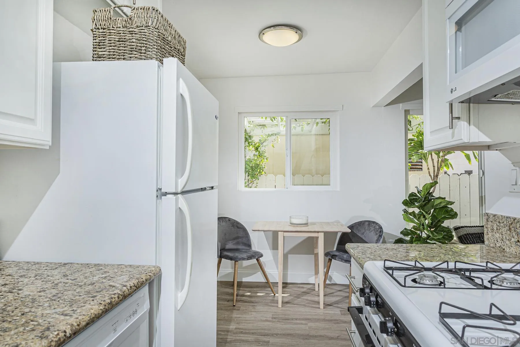 802 Vanderbilt Place San Diego, CA 92103 - Photo 9 of 14 a kitchen with stainless steel appliances granite countertop a stove refrigerator and a dining table