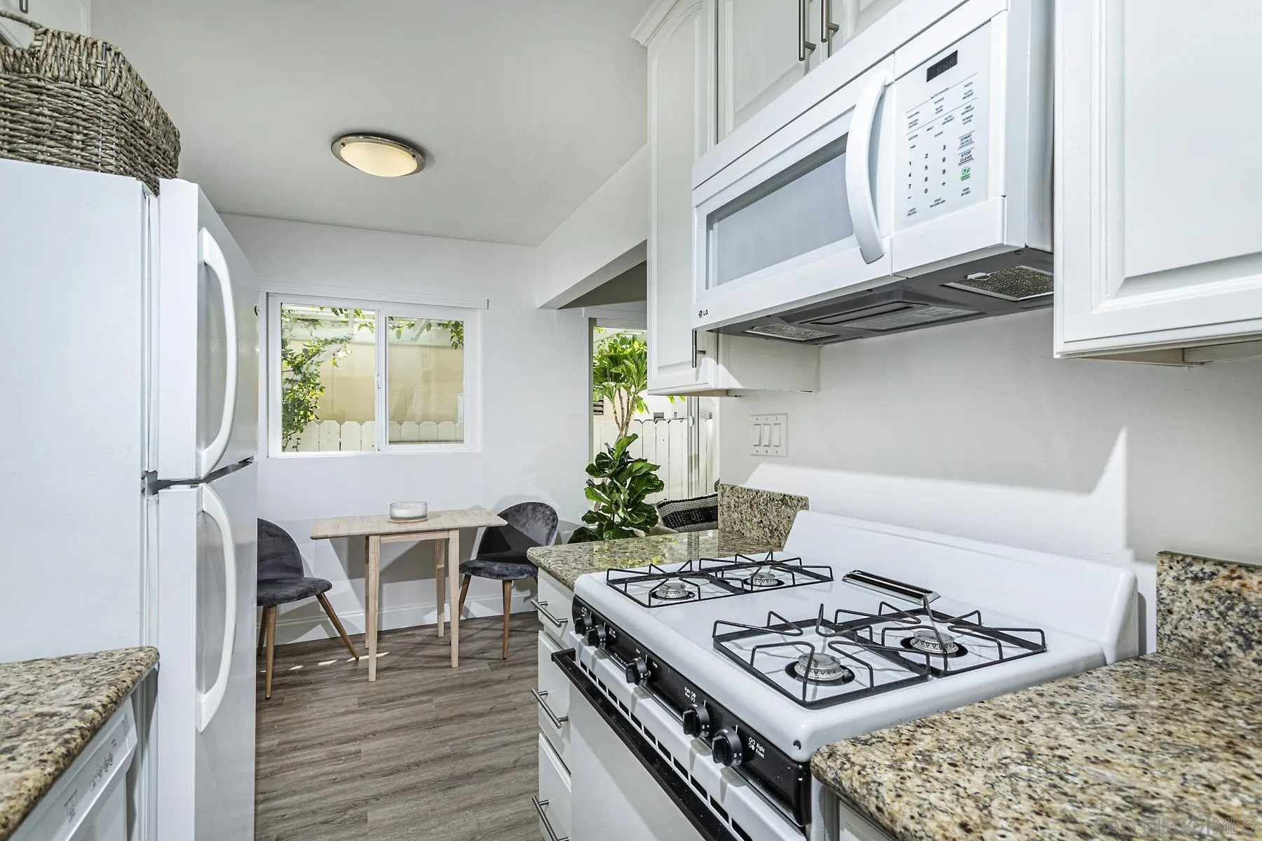 802 Vanderbilt Place San Diego, CA 92103 - Photo 10 of 14 a kitchen with stainless steel appliances granite countertop a stove a sink and a refrigerator